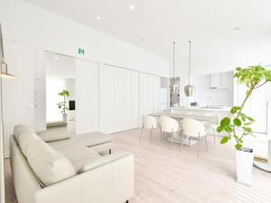 a white living room with a couch and a table at Seagull east coast Awaji - Vacation STAY 27684v in Awaji +18 photos