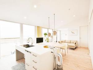a white kitchen with a sink and a table at Seagull east coast Awaji - Vacation STAY 27684v in Awaji