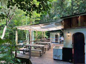 a wooden deck with picnic tables and a grill at NAKADAKI ART VILLAGE - Vacation STAY 41951v in Shiigi