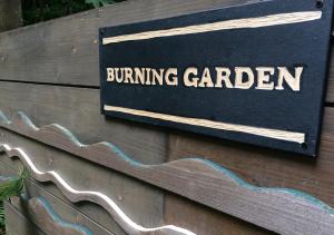 a sign for a building garden on a wooden wall at NAKADAKI ART VILLAGE - Vacation STAY 41947v in Shiigi