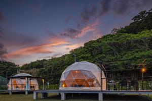 a couple of tents in a field at dusk at Glamping & Villa La-gom - Vacation STAY 82914v in Inatori