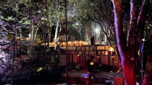 a garden at night with a fence and trees at Shimanto Yamamizuki - Vacation STAY 36953v in Shimanto +8 photos