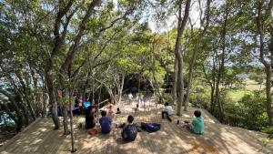 a group of people sitting on a deck in a park at Shimanto Yamamizuki - Vacation STAY 36947v in Shimanto +5 photos
