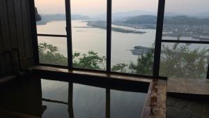 a room with a window looking out at a river at Shimanto Yamamizuki - Vacation STAY 36943v in Shimanto +6 photos