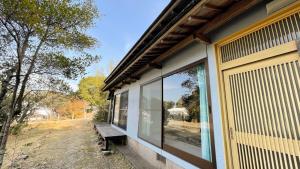 a window on the side of a house with a bench at Shimanto Yamamizuki - Vacation STAY 36943v in Shimanto