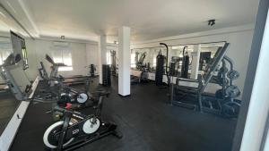 a gym with several treadmills and machines at Hotel Algorfa in Algorfa