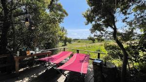 einen rosa Tisch und Stühle auf einer Holzterrasse in der Unterkunft Shimanto Yamamizuki - Vacation STAY 36959v in Shimanto + 12 Fotos