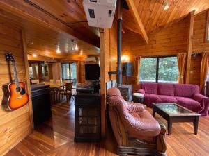 a living room with a purple couch and a guitar at NAKADAKI ART VILLAGE - Vacation STAY 41950v in Shiigi