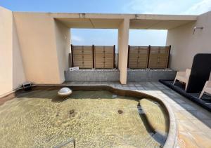 a room with a pool in the middle of a room at Glamping Base IZUMO "Lakeside Hot Spring Hotel Kun - Vacation STAY 42024v in Izumo