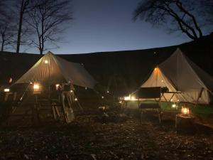un par de tiendas de campaña con luces en la oscuridad en Ciel's Forest Camp Site - Vacation STAY 71174v, en Shionada
