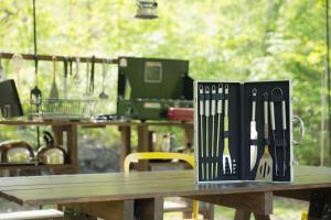 a wooden table with knives on top of it at Shirasu-Ojiro FLORA Campsite in the Natural Garden - Vacation STAY 00652v in Shirasu