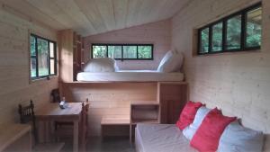a room with two beds and a table and a couch at Domaine de Cavailla in Marmont-Pachas