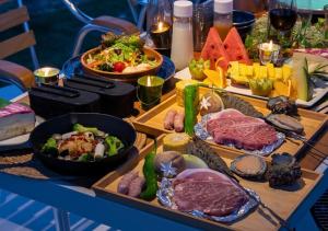 a table with many different types of food on it at Glamping Base IZUMO "Lakeside Hot Spring Hotel Kun - Vacation STAY 42012v in Izumo