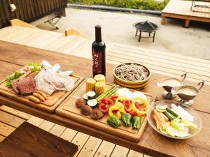 a table with a bottle of wine and a tray of food at HOLE37 - Vacation STAY 42192v in Hōjō +33 photos