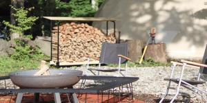 a group of chairs and a table and a pile of wood at The Day Post General Glamping Village Yamanakako - Vacation STAY 02720v in Yamanakako