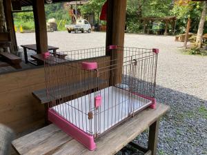 a bird cage sitting on top of a wooden bench at Logland Okumino - Camp - Vacation STAY 42153v in Gujo
