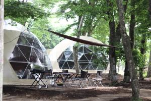 a group of tents with chairs in a park at The Day Post General Glamping Village Yamanakako - Vacation STAY 25049v in Yamanakako +4 photos
