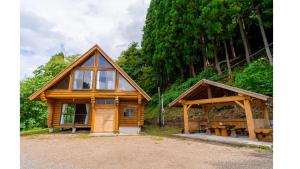 a log cabin with a tent and a picnic table at Logland Okumino - Camp - Vacation STAY 42253v in Gujo