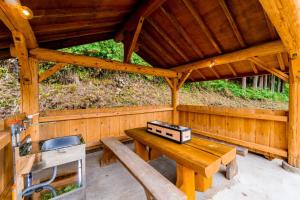 a wooden cabin with a table and a sink in it at Logland Okumino - Camp - Vacation STAY 42253v in Gujo