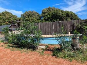 a backyard with a fence and a swimming pool at Asahi Seaside Cottage - Camp - Vacation STAY 42133v in Asahi
