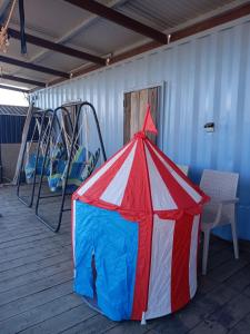 a red white and blue tent on a deck at Asahi Seaside Cottage - Camp - Vacation STAY 42133v in Asahi