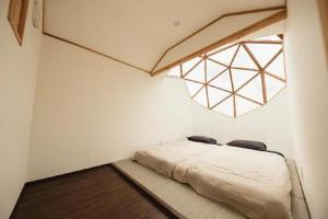 a bedroom with a bed in a room with a window at HOLE37 - Vacation STAY 42190v in Hōjō