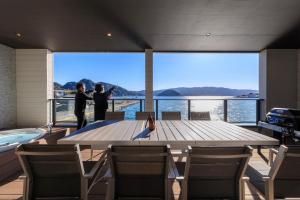 two men standing around a large table on a boat at GranTerace Sun - Vacation STAY 15256 in Numazu