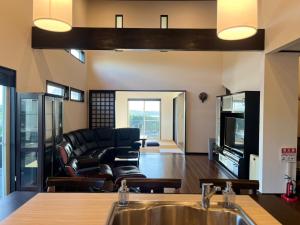 a living room with a couch and a television at Twilight Hills - Vacation STAY 32702v in Motobu