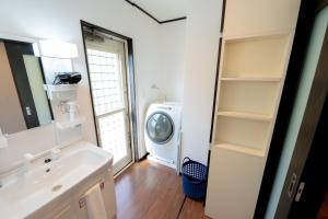 a bathroom with a sink and a washing machine at Twilight Hills - Vacation STAY 32702v in Motobu +46 photos