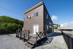 a house with a staircase leading up to it at Twilight Hills - Vacation STAY 32702v in Motobu