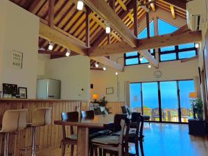 a dining room with a table and chairs in a building at Inori Resort SORAKAZE - Vacation STAY 49443v in Shushi +10 photos