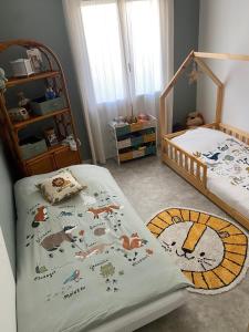 a bedroom with two beds with animals on it at Charmante maison de vacances in Saint-André-de-Cubzac +1 photo