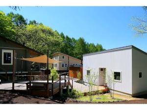 a patio with an umbrella next to a building at Class Vesso Tateshina - Vacation STAY 51898v in Chino +3 photos