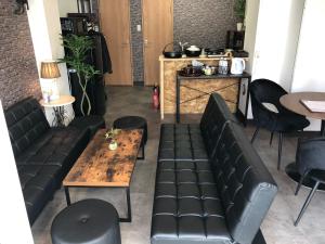 a restaurant with black leather seats and a wooden table at Cool Inn Otaru - Vacation STAY 42415v in Otaru +23 photos
