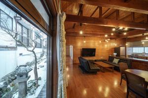 a living room with a table and a large window at Osugi no Yado - Vacation STAY 43977v in Yufuin