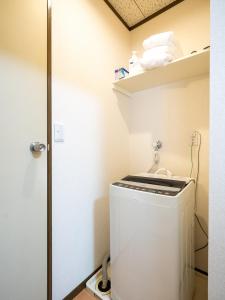 a small bathroom with a washing machine in a room at maison elegance - Vacation STAY 15342 in Tokyo +27 photos
