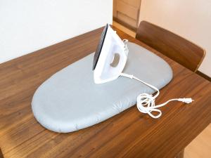a white phone on top of a pillow on a table at maison elegance - Vacation STAY 15342 in Tokyo