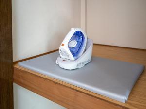 a iron sitting on top of a wooden shelf at maison elegance - Vacation STAY 15341 in Tokyo