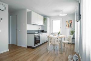 a kitchen with a table and chairs in a room at La Croce Apartments in Castelnovo neʼ Monti