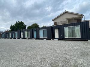 a row of black modular homes in a parking lot at Ko-eda Village - Camp - Vacation STAY 42084v in Iioka