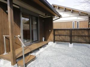 a house with a wooden porch and a balcony at Hisetsu no Taki Campsite - Camp - Vacation STAY 42072v in Ōzato
