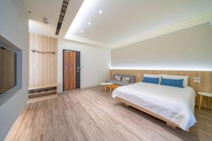 a bedroom with a bed and a flat screen tv at All In One Entire Home in Tainan
