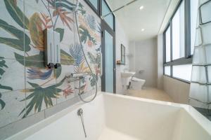 a bathroom with a bath tub and a toilet at All In One Entire Home in Tainan