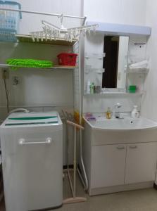 a bathroom with a sink and a mirror at Private inn “Come! Akae House” - Vacation STAY 61227v in Toyama