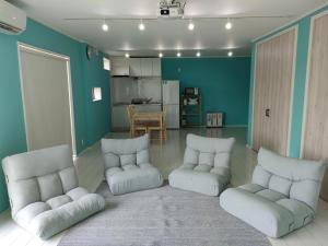a living room with two chairs and a kitchen at Tateyama City - Camp - Vacation STAY 42217v in Nago