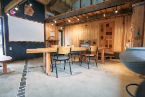 a dining room with a wooden table and chairs at Fujino Minshuku - Vacation STAY 65039v in Bizen