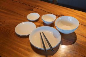 a group of bowls and chopsticks on a wooden table at MAGONI - Vacation STAY 66651v in Kaga