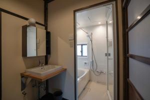 a bathroom with a sink and a shower and a tub at MAGONI - Vacation STAY 66651v in Kaga