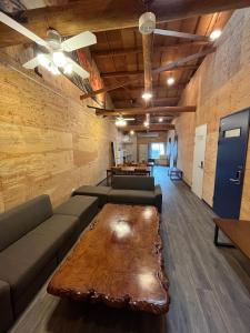a living room with a couch and a coffee table at K-style Nishijin backpackers - Vacation STAY 17741 in Kyoto