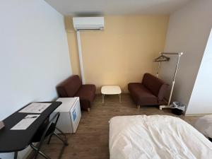 a hospital room with a bed and a table and chairs at K-style Nishijin backpackers - Vacation STAY 15407 in Kyoto +1 photo